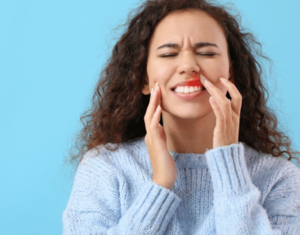 Woman showing pain from gum disease - The Link Between Diabetes & Oral Health | North Down Dental