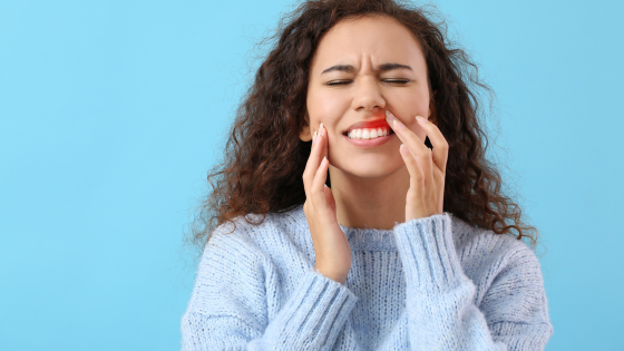 Woman showing pain from gum disease - The Link Between Diabetes & Oral Health | North Down Dental