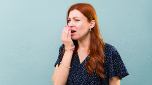 Woman complaing of bad breath because of gum disease